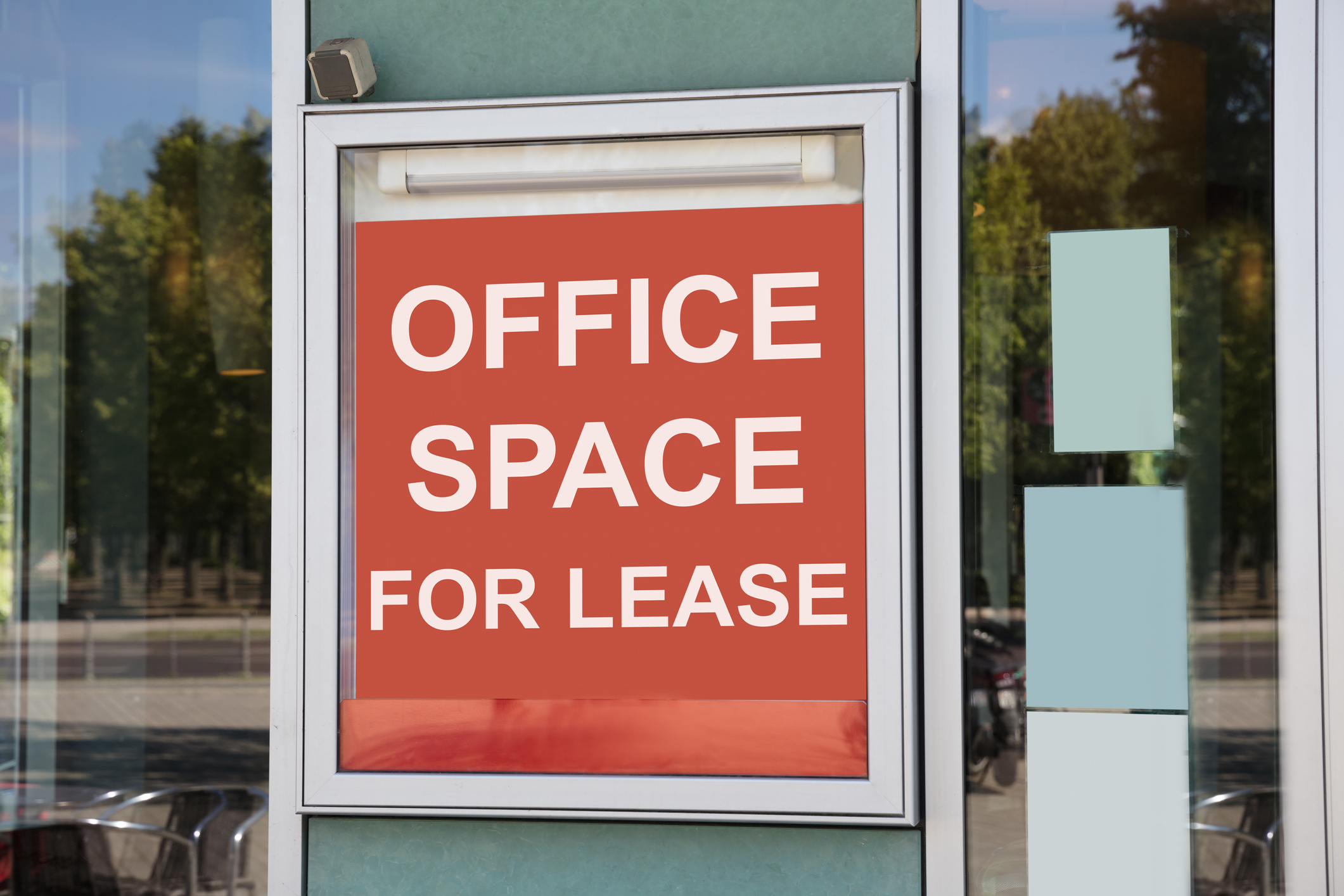 Sign in a storefront window that says office space for lease